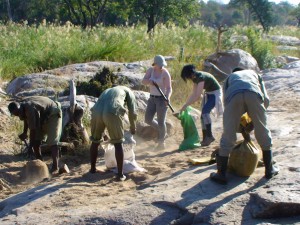 TurgweTrust team and volonteer building a dam in the turgwe river.